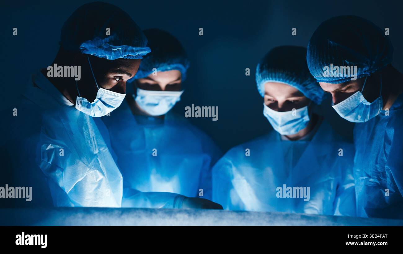 Perform Operation. Surgeon Team Working In Hospital Stock Photo