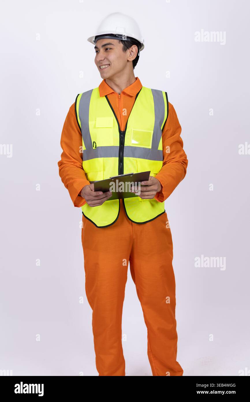 Construction worker in orange uniform holding a tablet Stock Photo