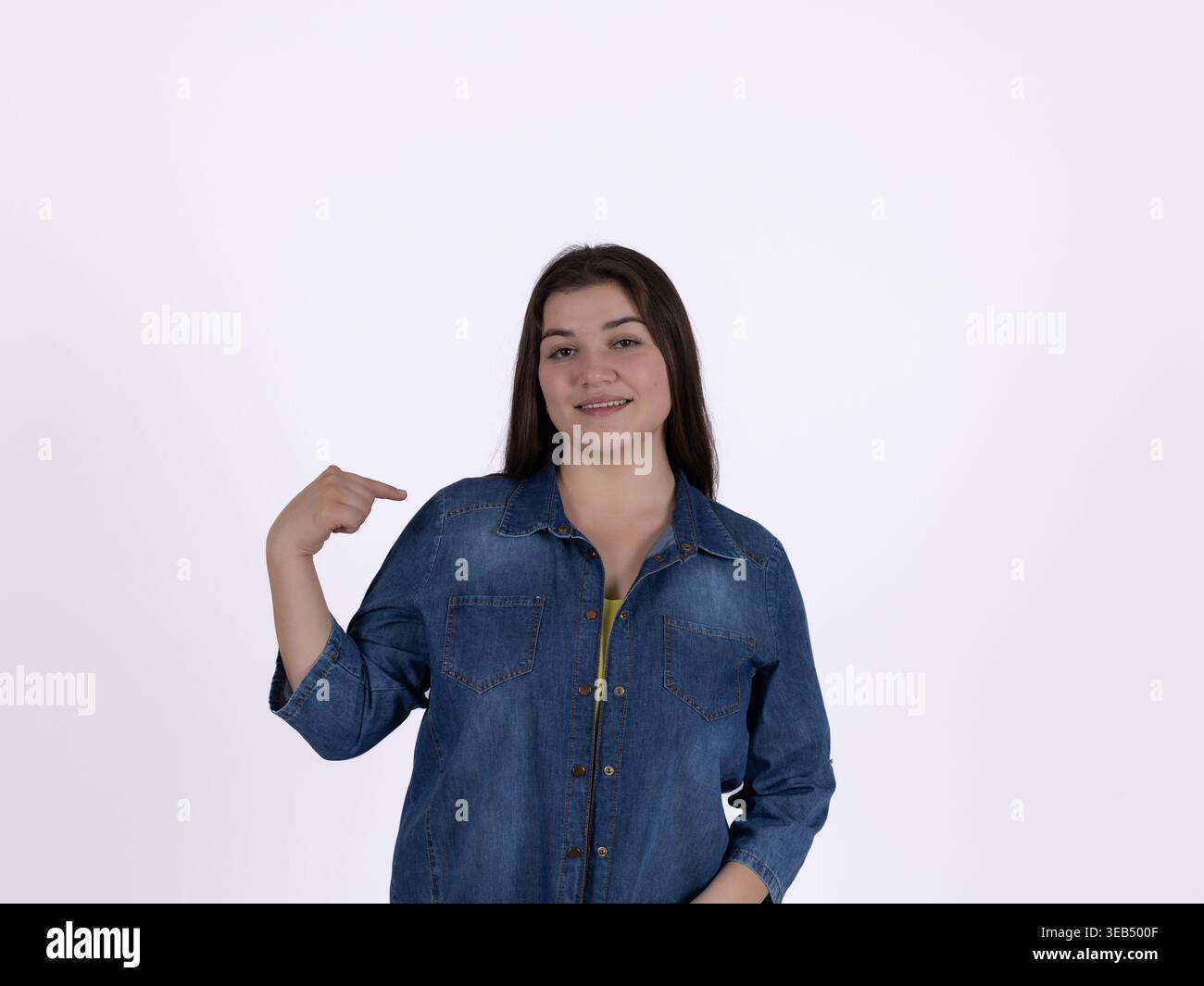 Young woman pointing at herself with a thumb Stock Photo