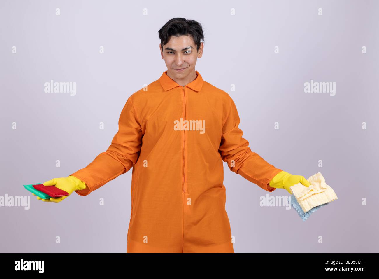 Man in orange uniform holding work equipment Stock Photo