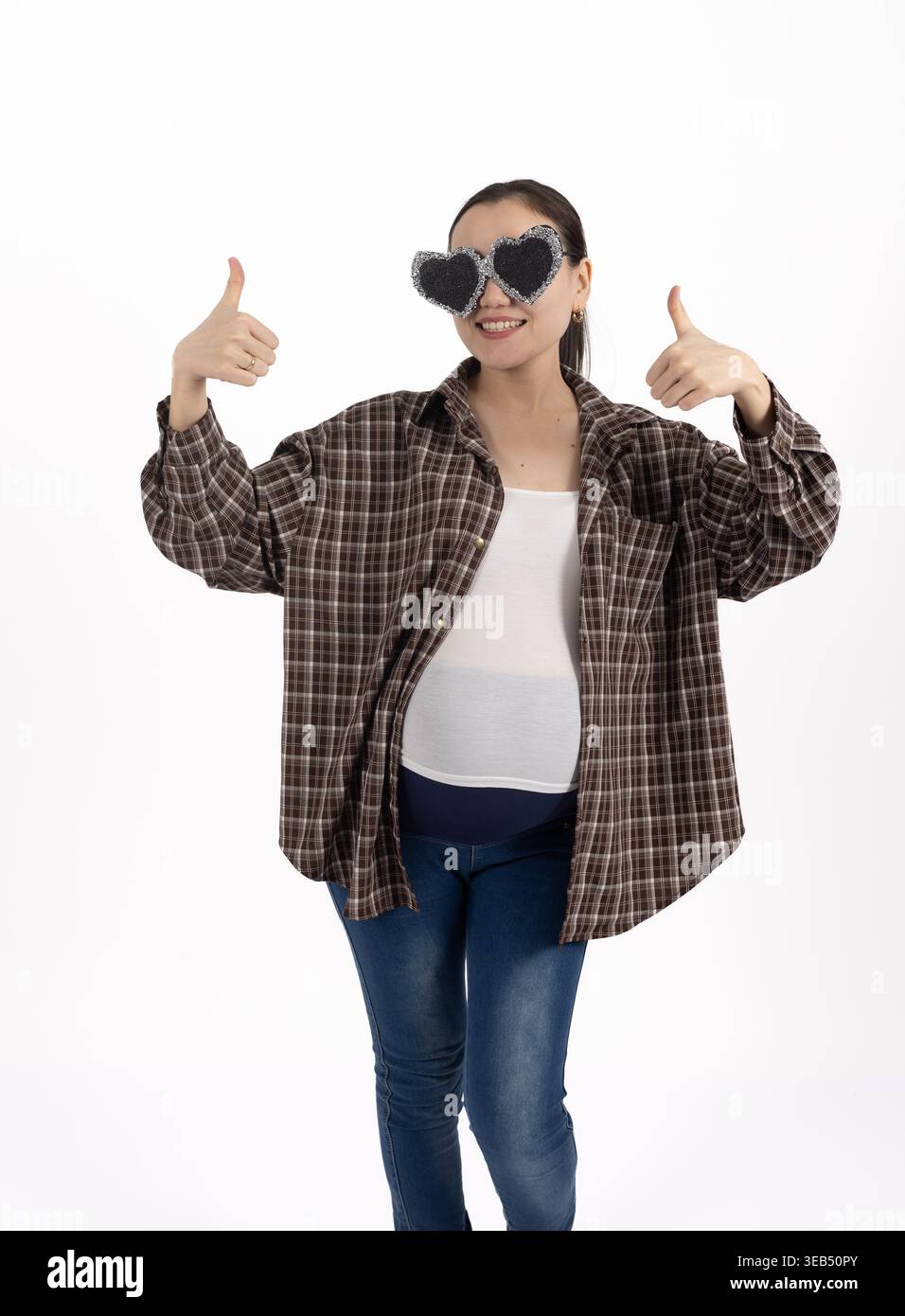 Man making thumbs up gesture with both hands while smiling Stock Photo