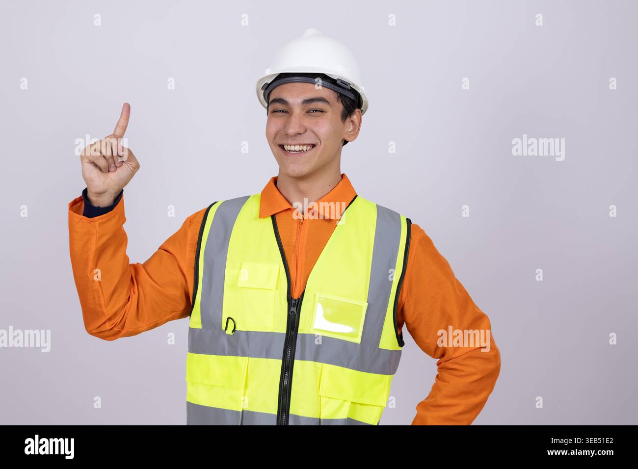 Happy construction worker pointing up with a finger Stock Photo