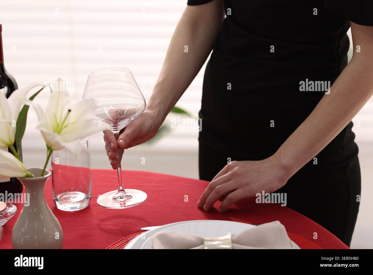 Woman setting table for dinner at home, closeup Stock Photo