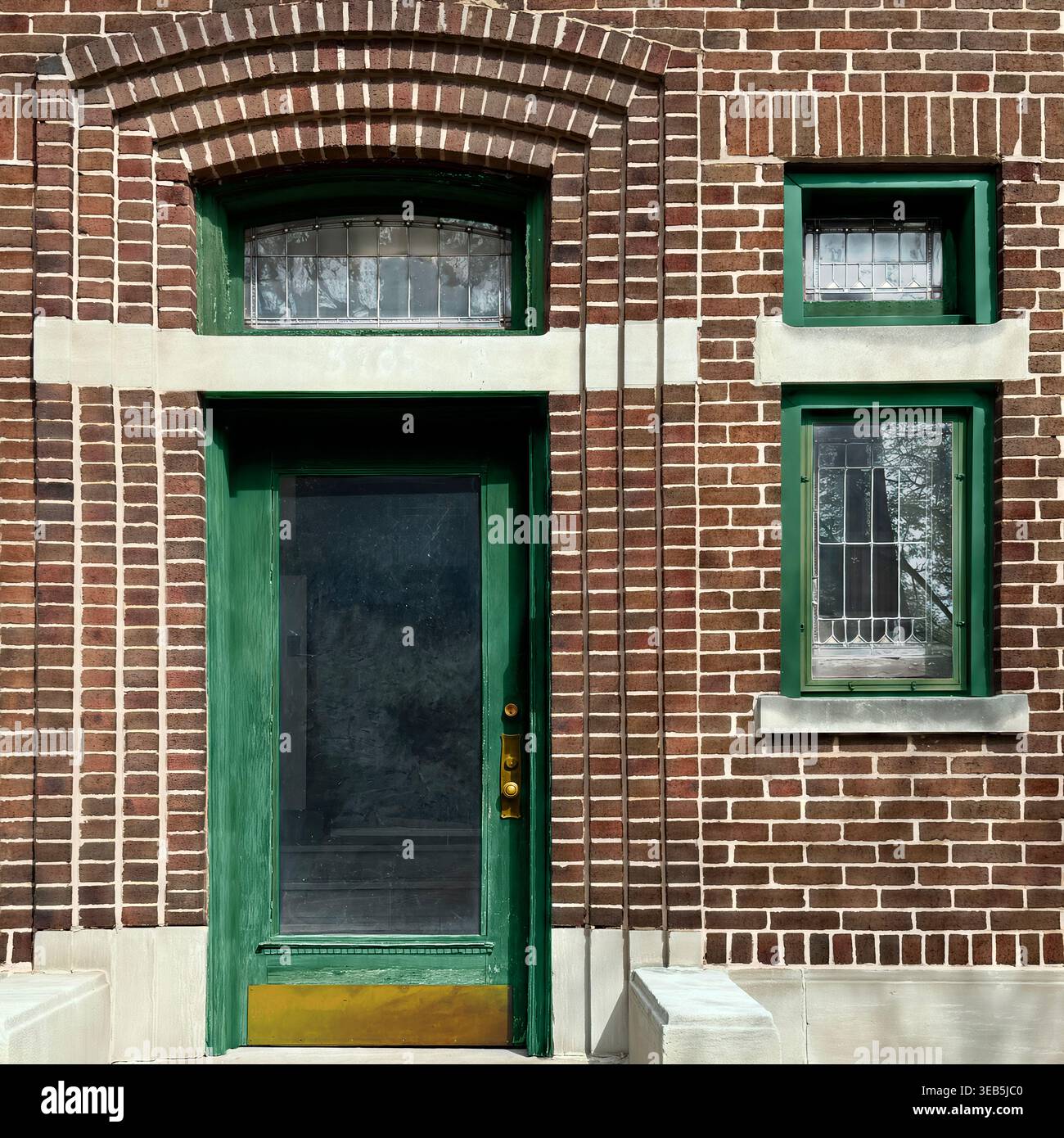 Green entry door set in red brick facade with adjacent window and ...