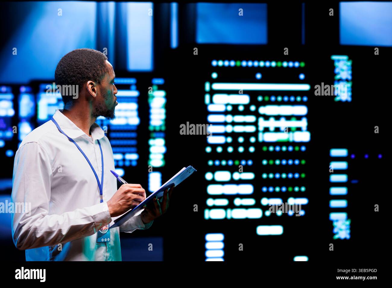 Experienced admin analyzing server systems performing data backups and providing centralized storage. Technician adjusting Uninterruptible Power Supply ensuring proper operating Stock Photo