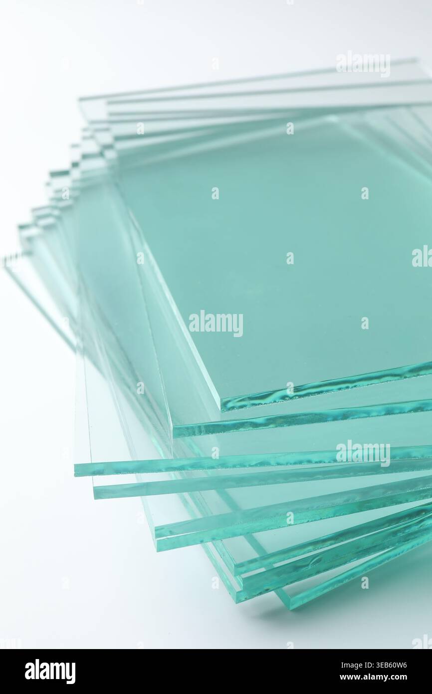 Stack of glass sheets on light background, closeup Stock Photo