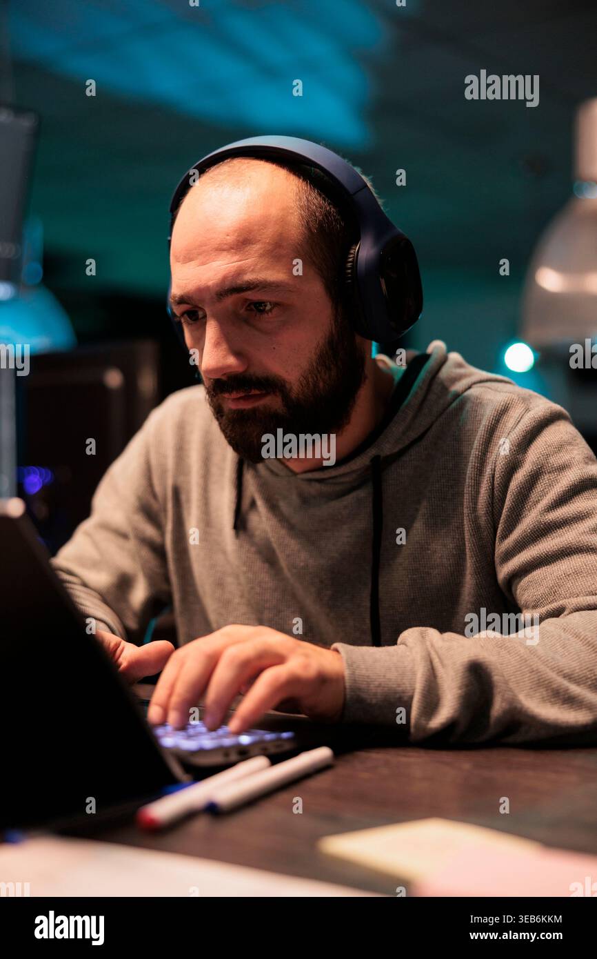 Database admin typing code and creating algorithm for it startup company, writing html script on multiple monitors. App developer working with temrinal window and programming source code. Stock Photo