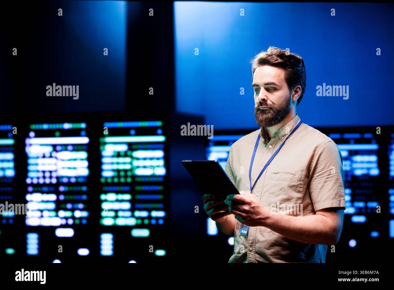 Admin walking in data center supporting AI through powerful computing operations, hosting specialized storage servers. Engineer ensuring high tech facility internal hardware functions properly Stock Photo