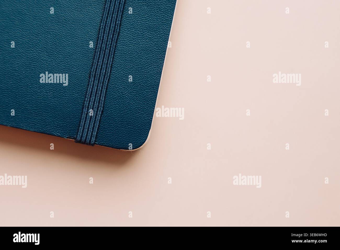 Closed blue notebook on beige background in minimal style Stock Photo