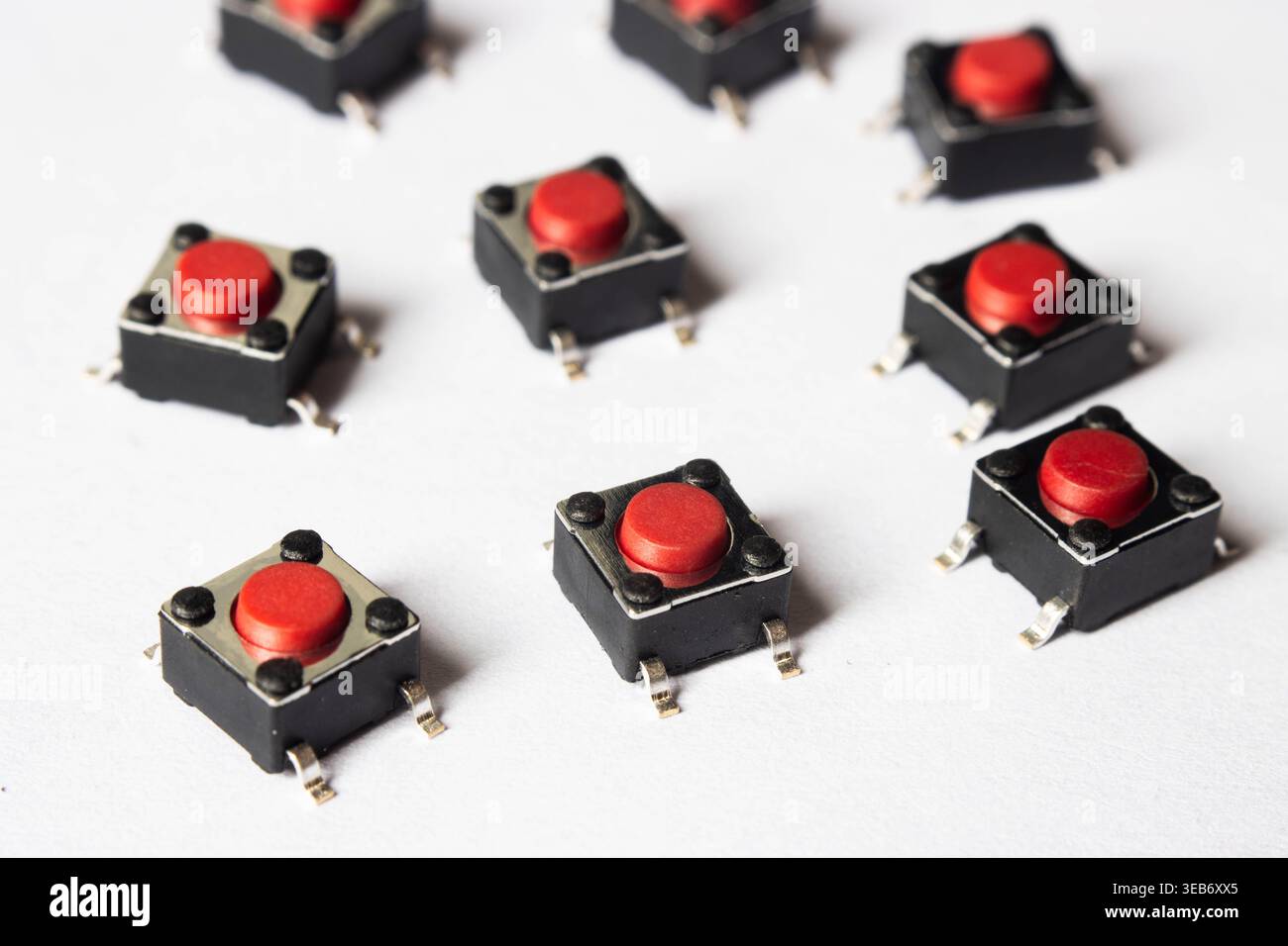 Red tactile push buttons on white background arranged in pattern Stock Photo