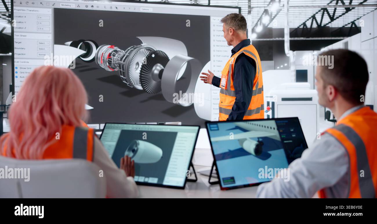 Aerospace Engineer Leads Diverse Team Using CAD Software For Aircraft Design. Stock Photo