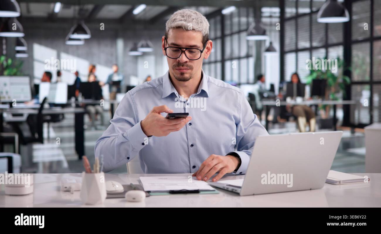 Hispanic Office Employee Capturing Document Image For Optical Character Recognition Using Mobile Device Stock Photo