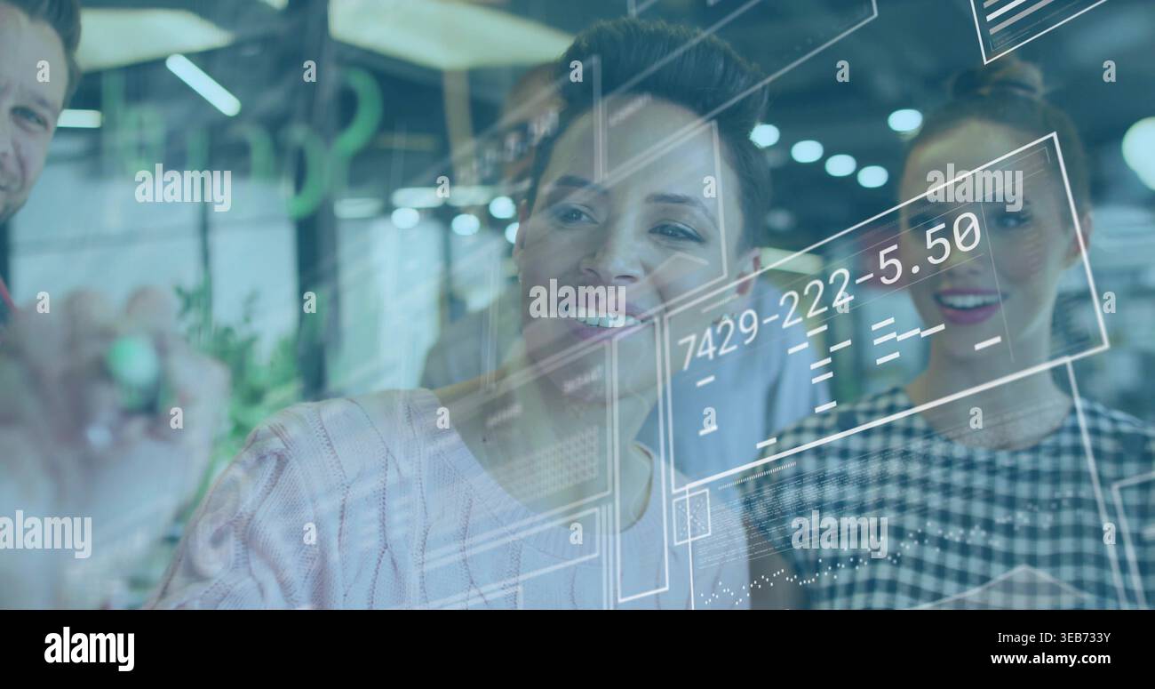 Collaborating team in business writing on glass board at open office, showing UI numbers and marker Stock Photo