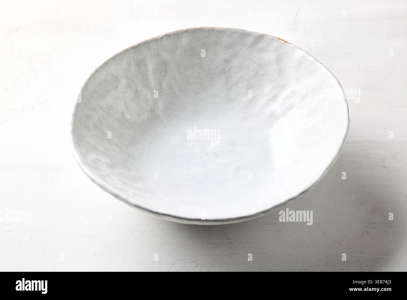 empty white bowl on white kitchen table Stock Photo