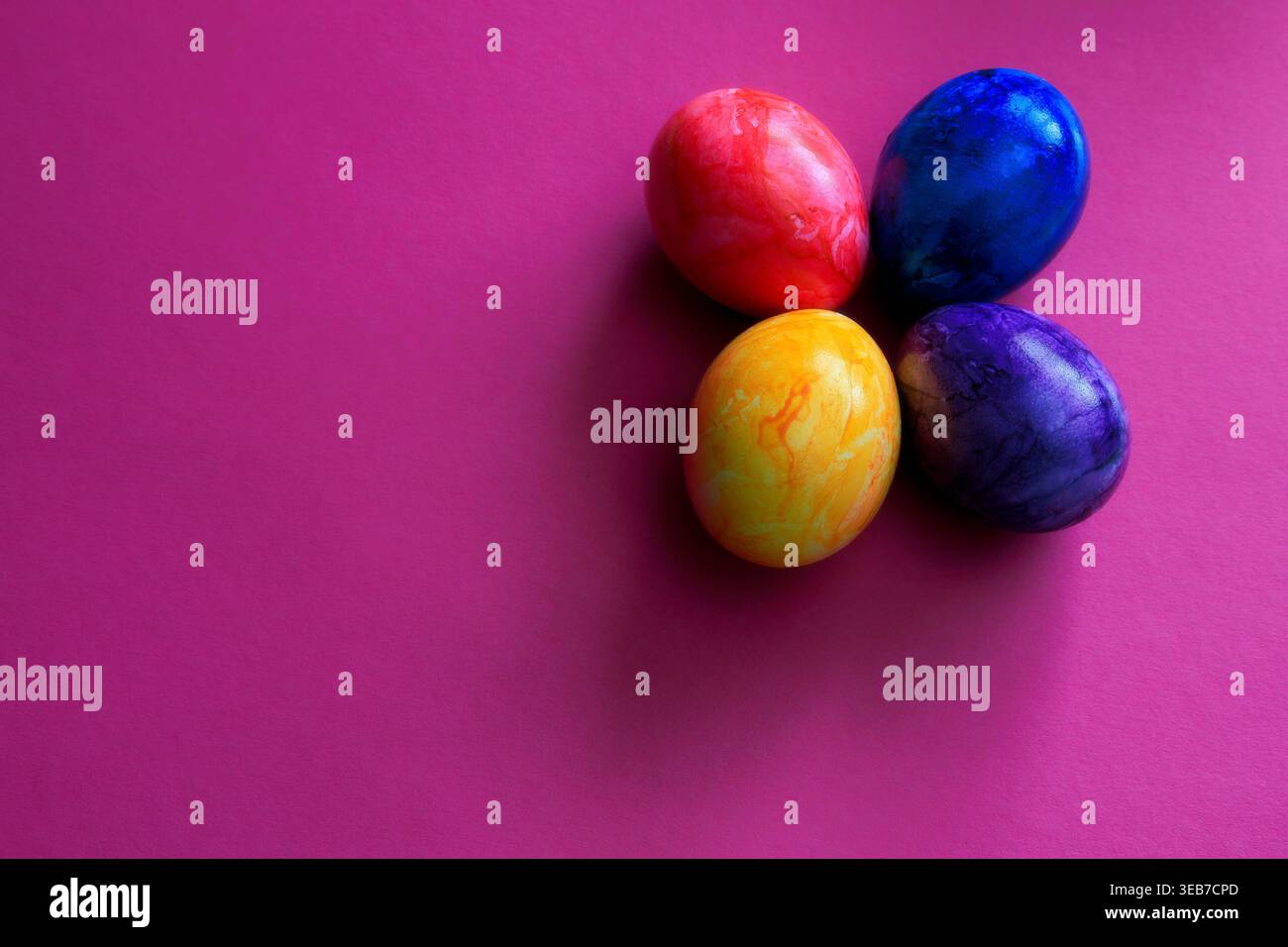 Different colored Easter eggs on a colored background Stock Photo
