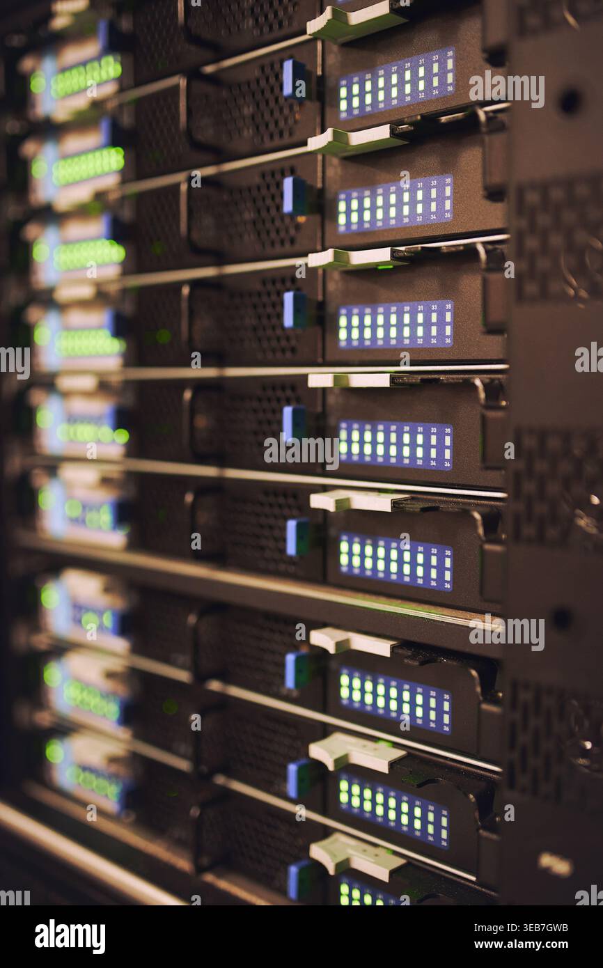 Closeup, servers and rack in empty data center for cybersecurity, IT hardware and infrastructure. Mainframe, network and database machine for power Stock Photo