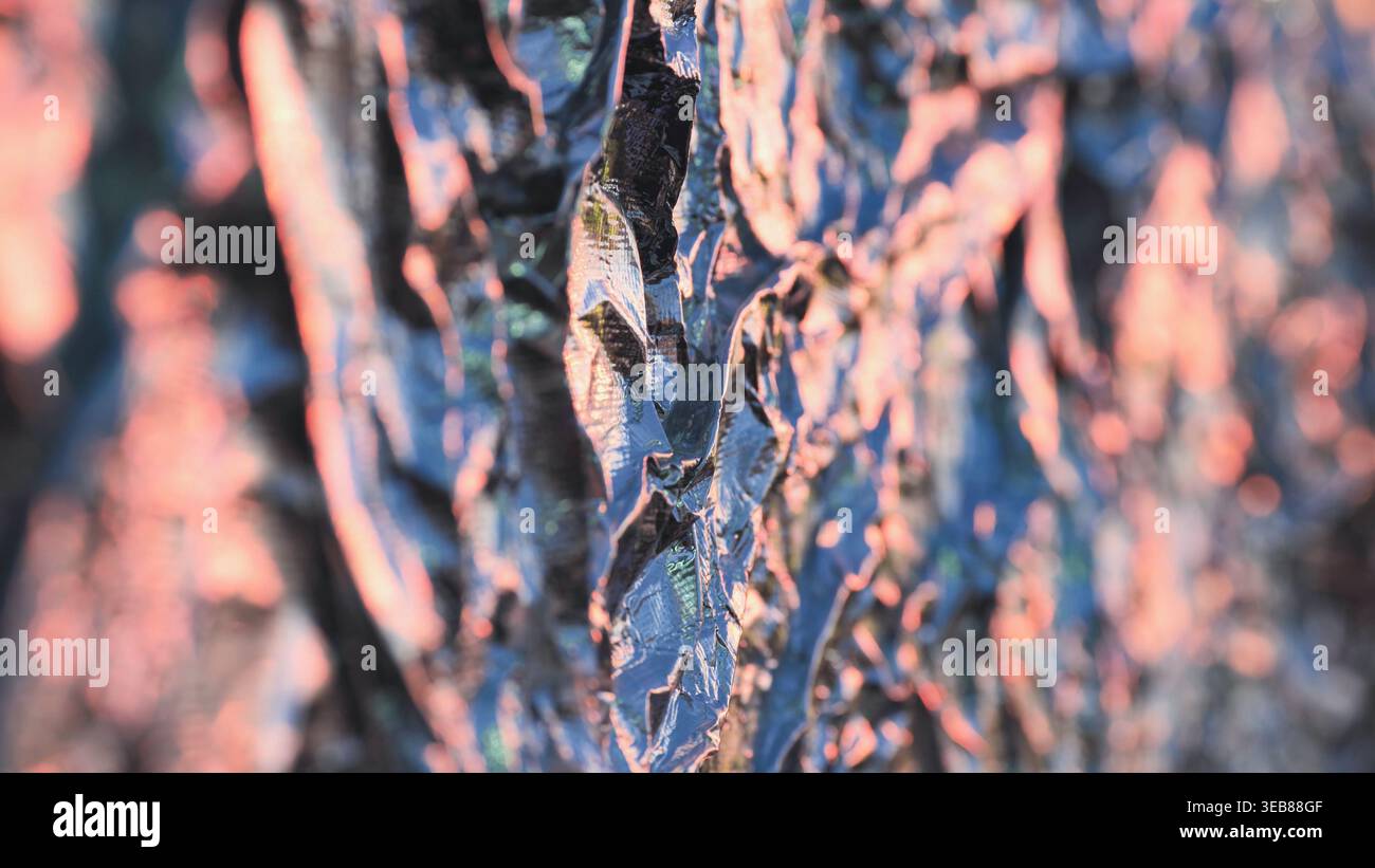 Reflecting light on abstract metallic texture creating a vibrant color gradient background Stock Photo