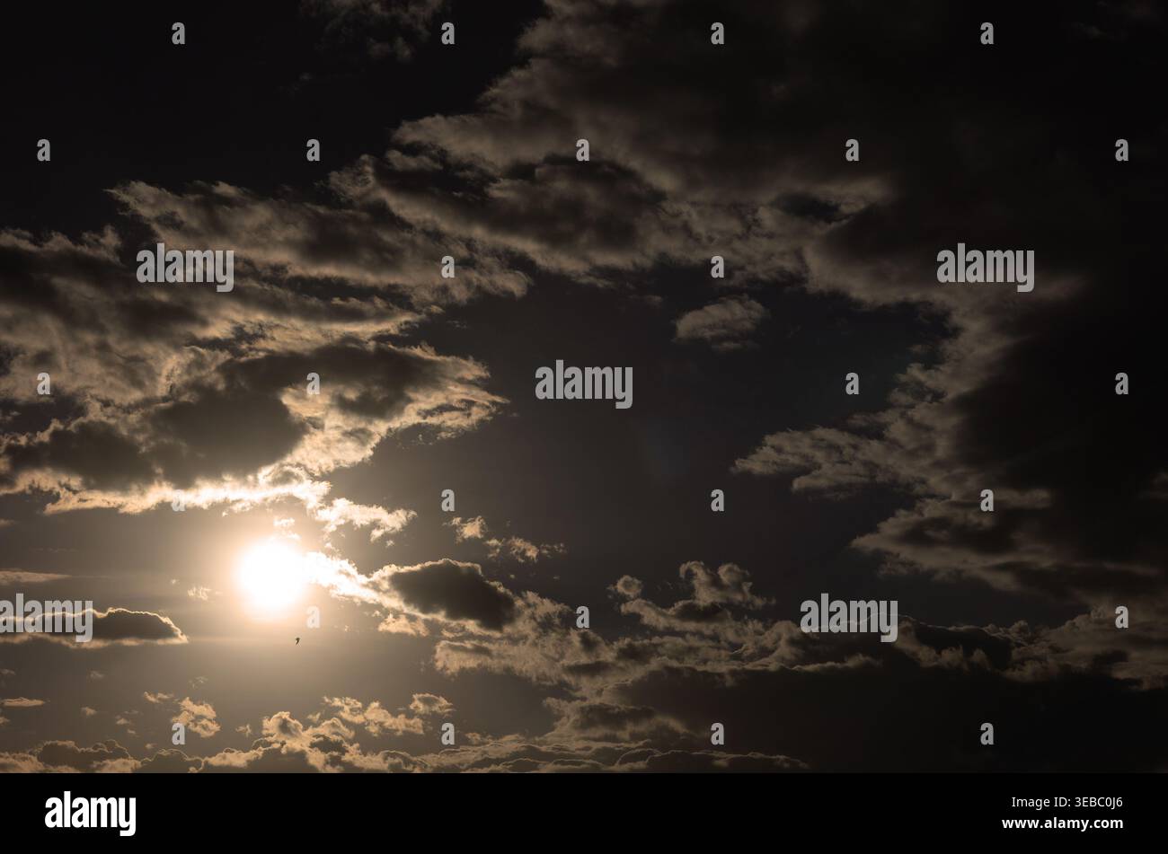 Dramatic evening sky. The sun is shining through the clouds. Stock Photo