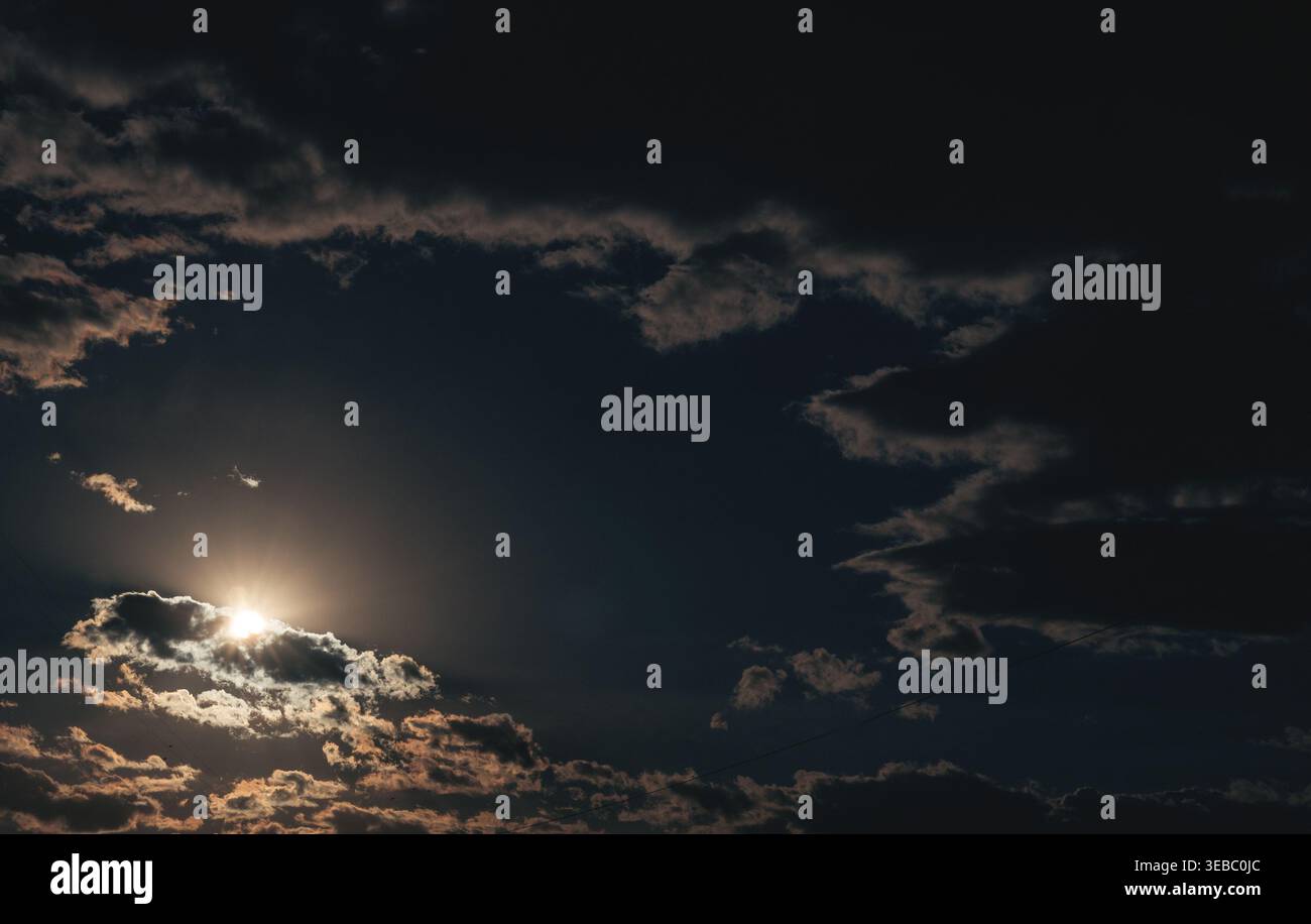 Dramatic evening sky. The sun is shining through the clouds. Stock Photo