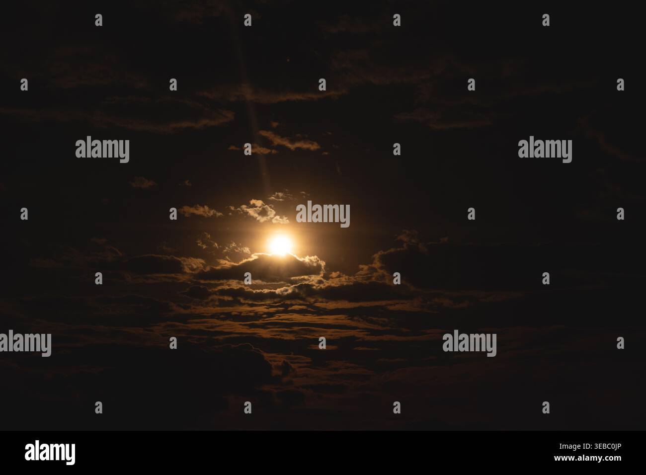Dramatic evening sky. The sun is shining through the clouds. Stock Photo