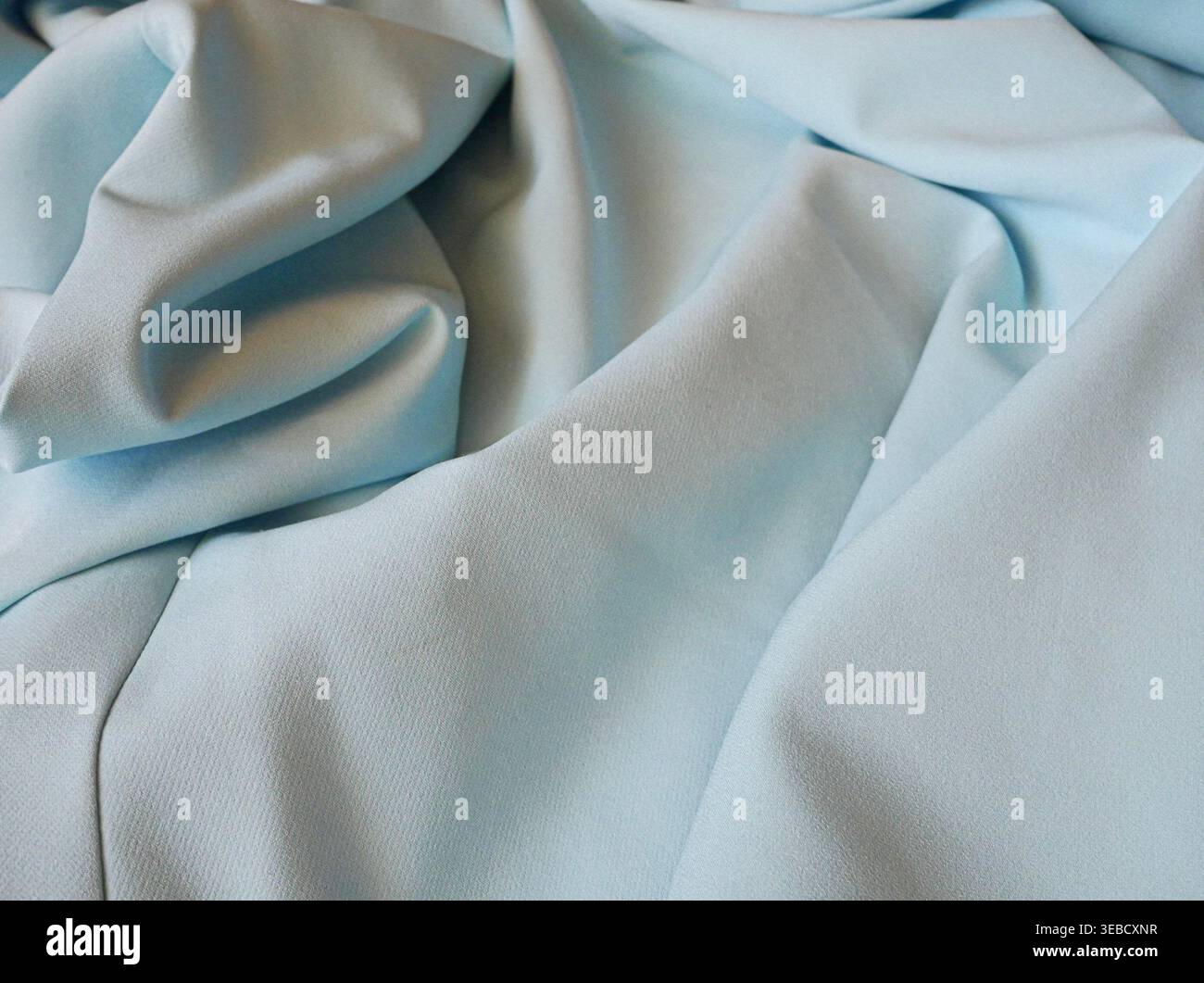 Light blue fabric folds close-up Stock Photo