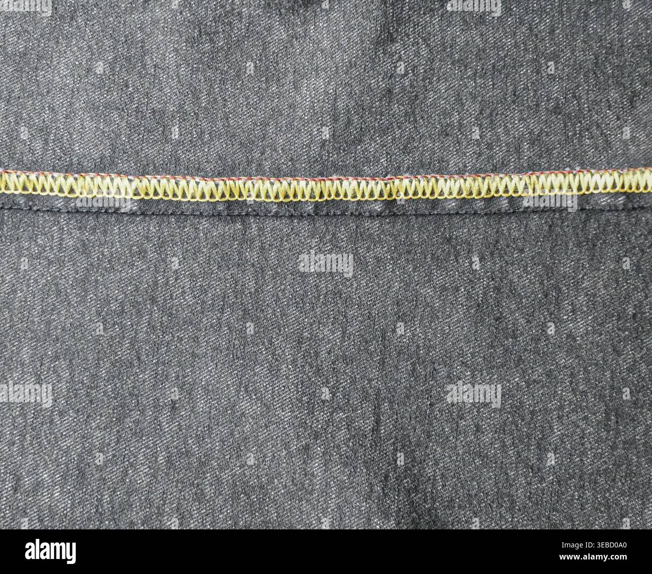 Dark denim overlock seam close-up Stock Photo
