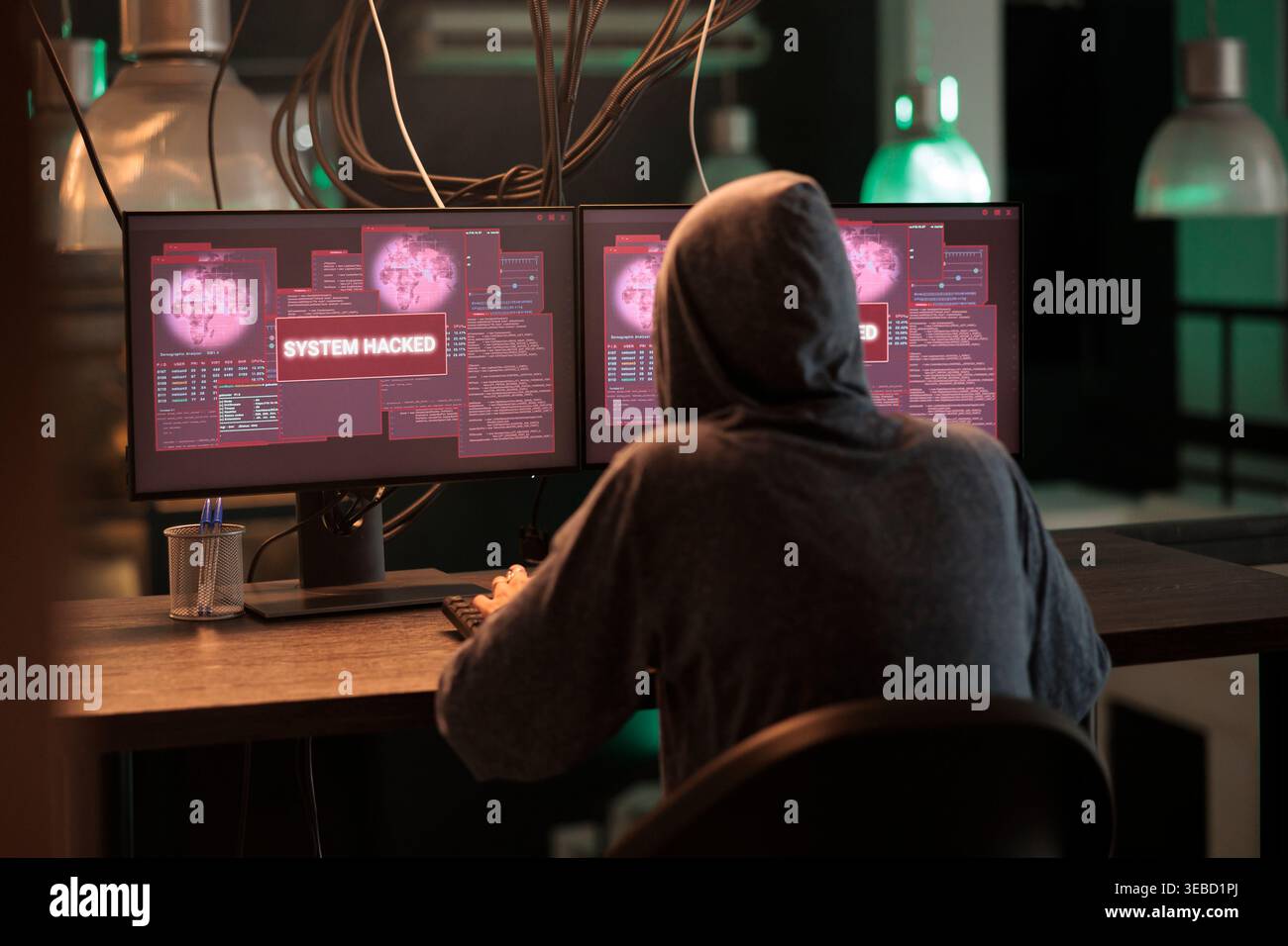 Internet thief creating security breach and hacking computer system, stealing important data or passwords. Young hacker planting trojan virus, breaking into database and programming software. Stock Photo