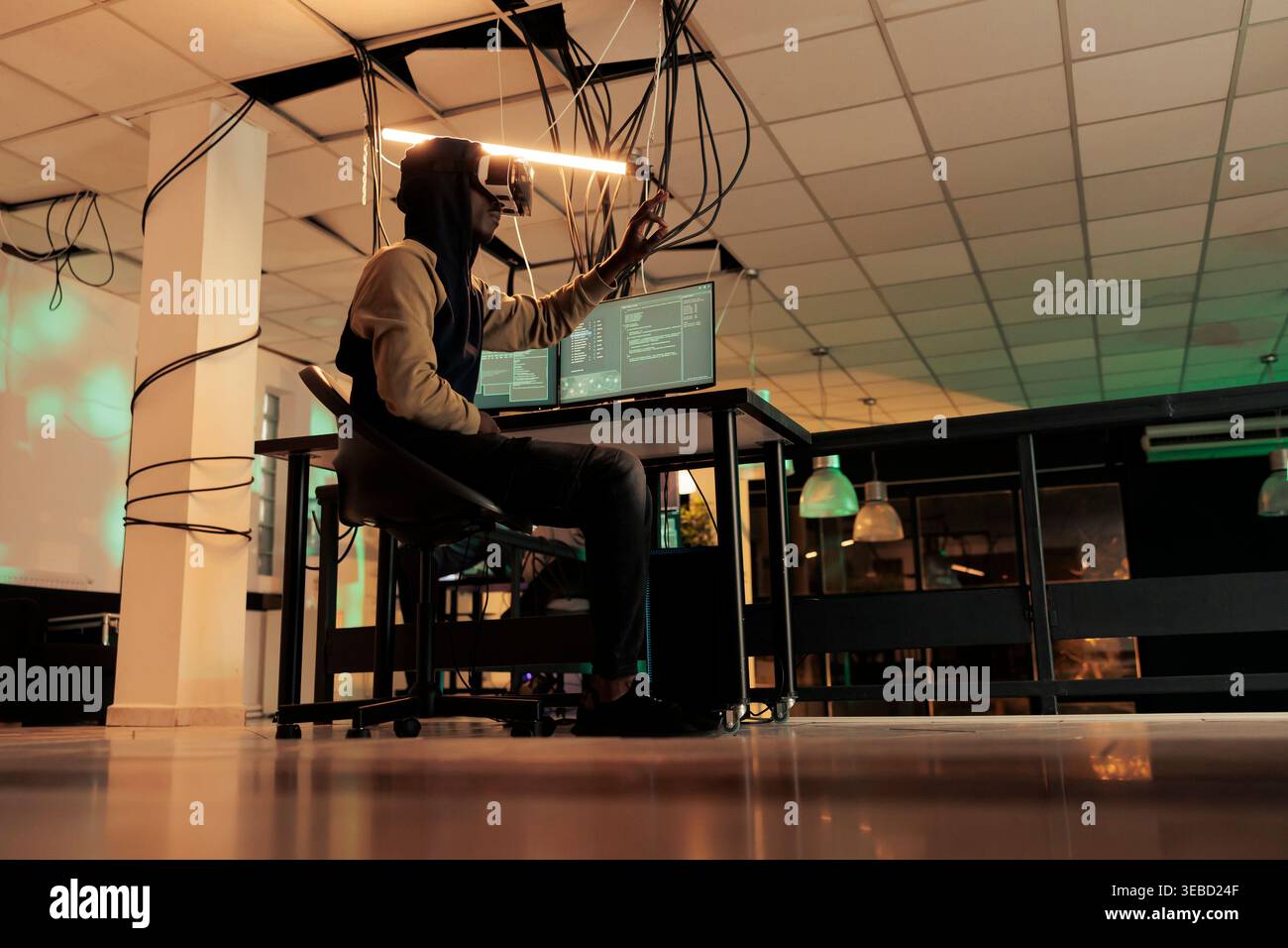 Hacker breaking into computer system in vr glasses, hacking database, spyware coding simulation. African american man cracking server password, data breach in metaverse, cybercrime Stock Photo