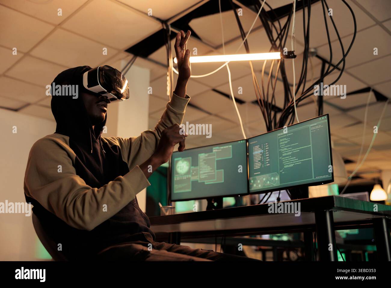 Hacker breaking into databse in vr glasses, spyware coding experience, african american man cracking computer system password in metaverse. Cybercrime, internet criminal developing malware Stock Photo
