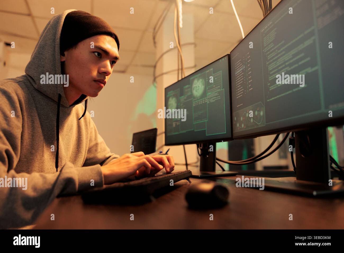 Cybercrime, computer fraud, man hacking system, coding malware, stealing database privacy information. Internet criminal cracking online server password, developing spyware at night time Stock Photo