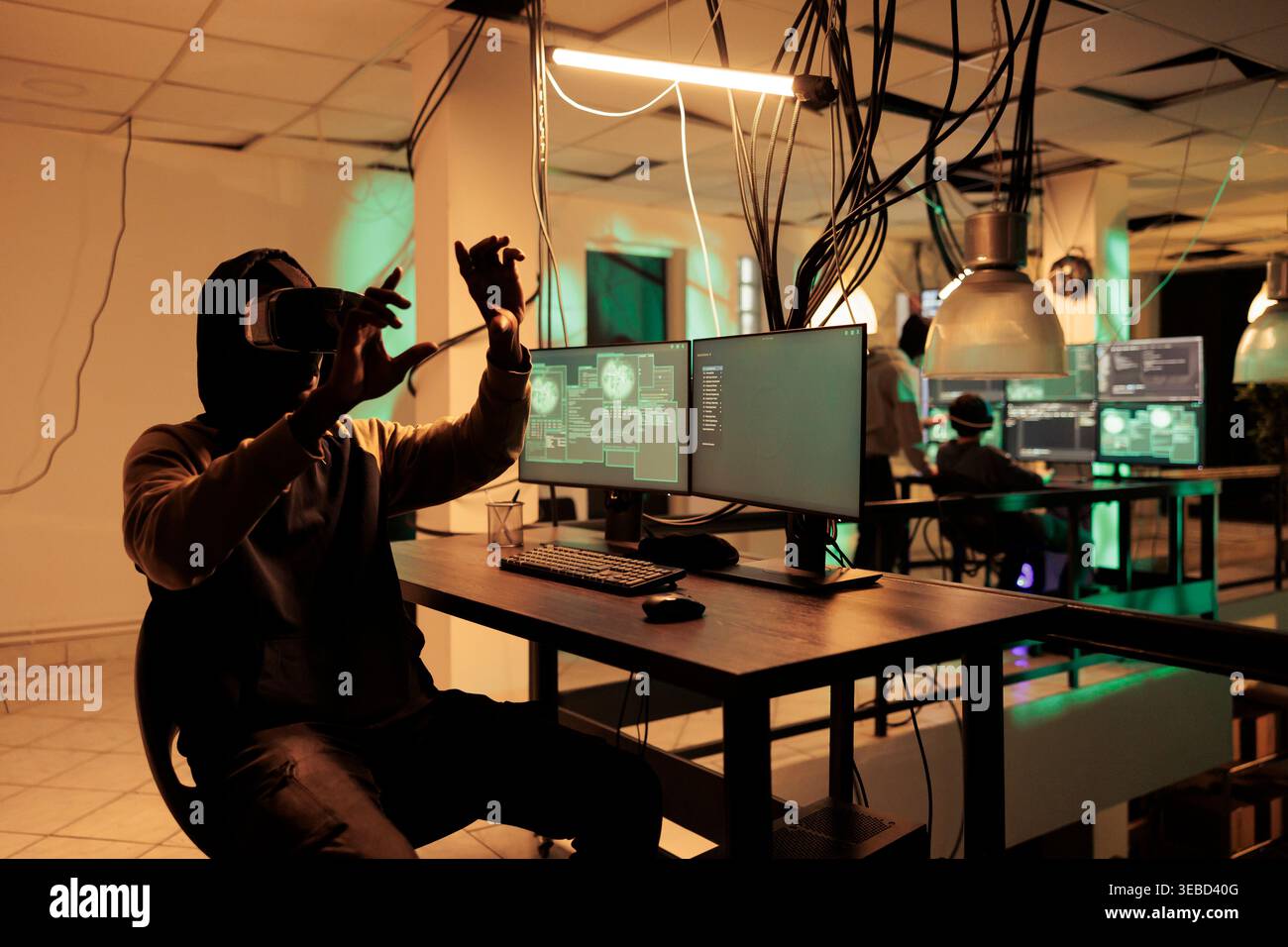 Male thief programming computer virus in vr headset, cracking database password in metaverse using interactive 3d glasses. Hacker coding malware in virtual reality gadget at night. Stock Photo