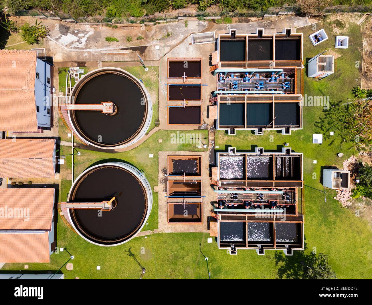 Aerial view of a water treatment plant featuring circular clarifiers ...