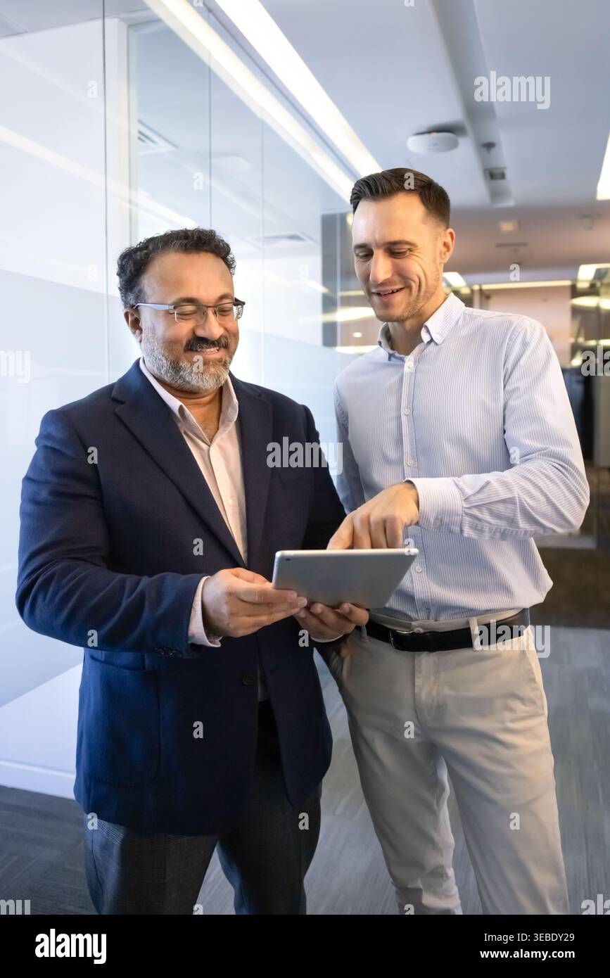 Business professionals using digital tablet during workday Stock Photo