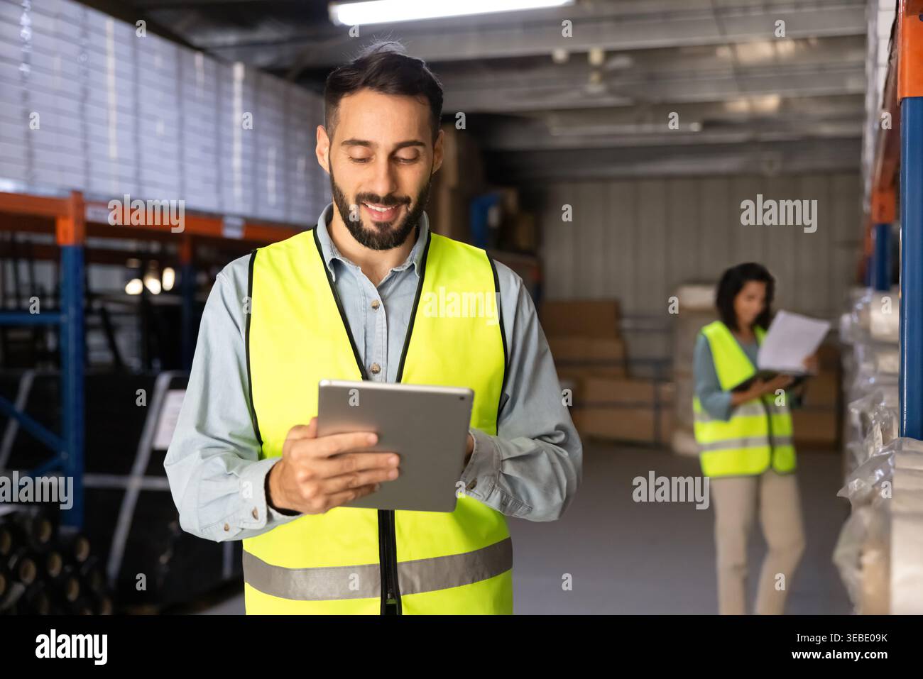 Male logistics specialist using digital tablet in warehouse Stock Photo