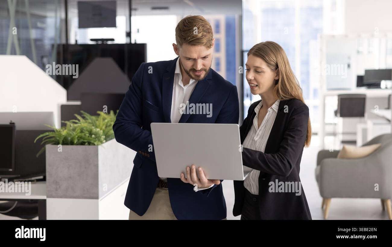 Colleagues engaged in productive teamwork using laptop Stock Photo