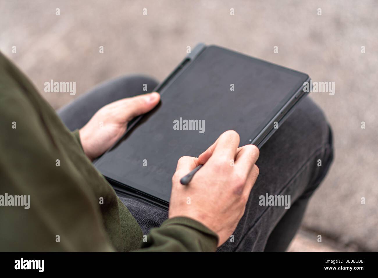 Person using stylus on portable tablet device Stock Photo