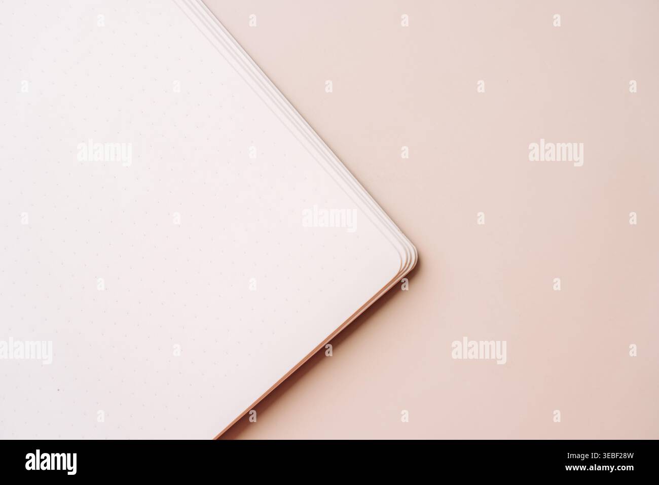 Notebook corner on beige background with soft light Stock Photo