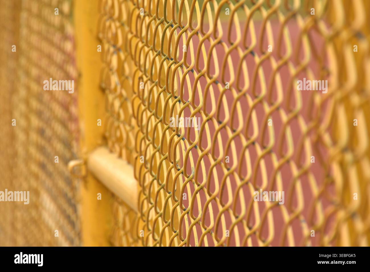 close up of yellow iron door wire net background and texture Stock Photo