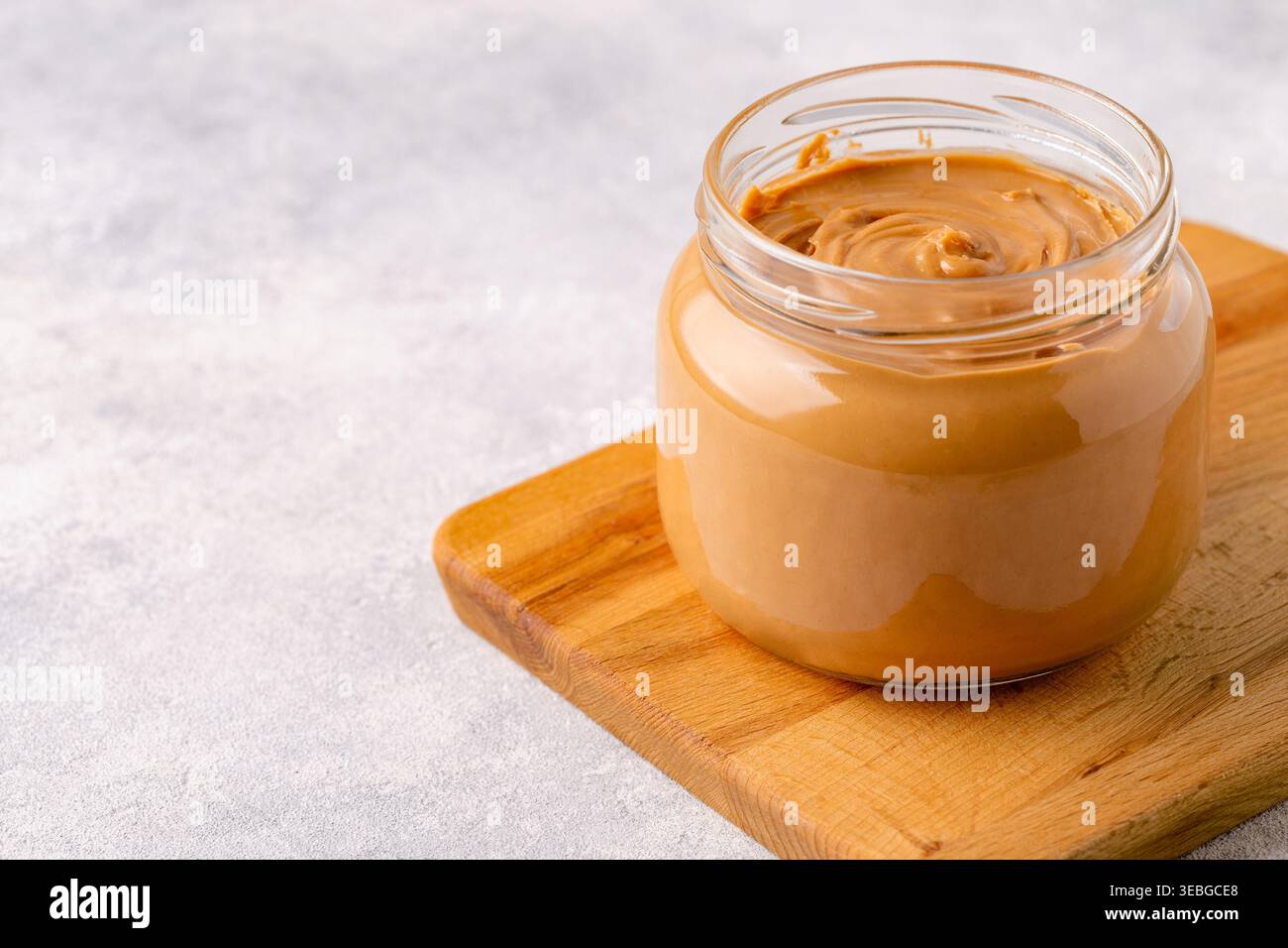 Peanut paste in an open jar Stock Photo