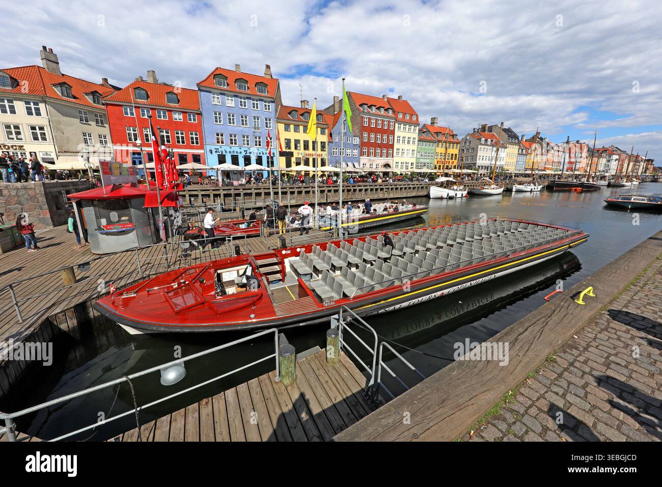 Nyhavn canal in Copenhagen, looking east from near Kongens Nytorv with colourful houses and sightseeing boats. Stock Photo