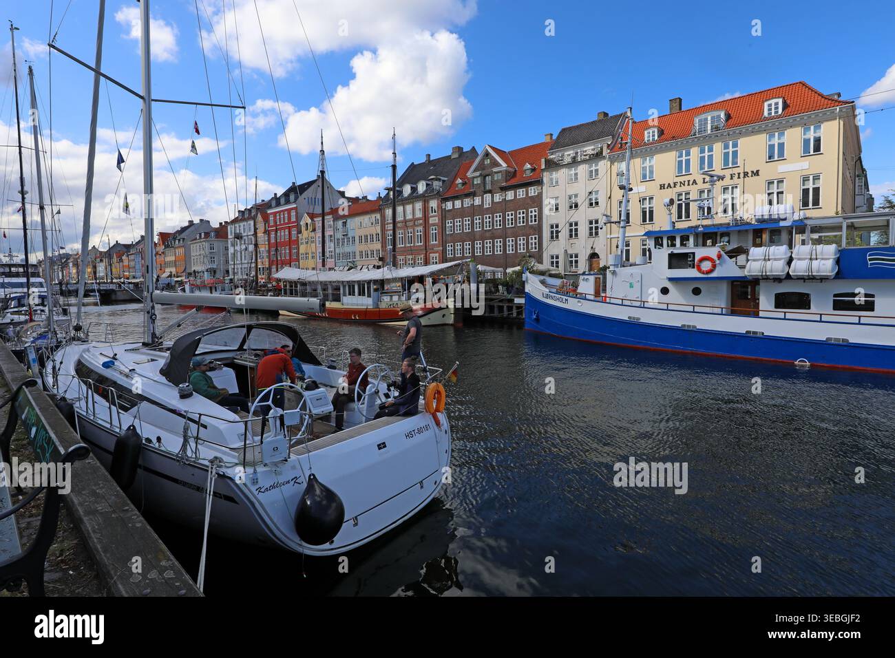 Nyhavn canal in Copenhagen, viewed east from near Kongens Nytorv with colourful harbour houses, boats and waterfront restaurants. Stock Photo