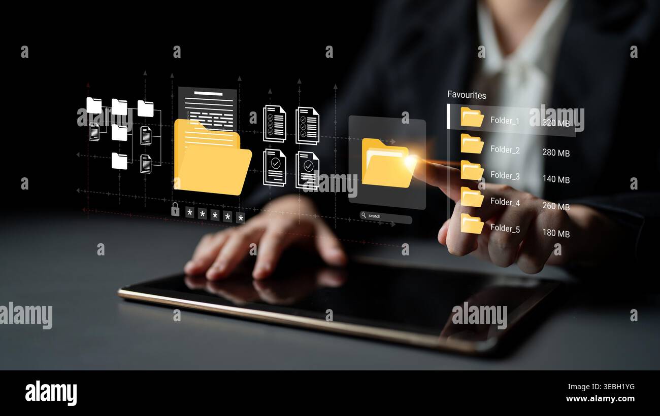 A business professional interacts with a tablet, showcasing a digital interface for efficient file management and organization, emphasizing modern Stock Photo