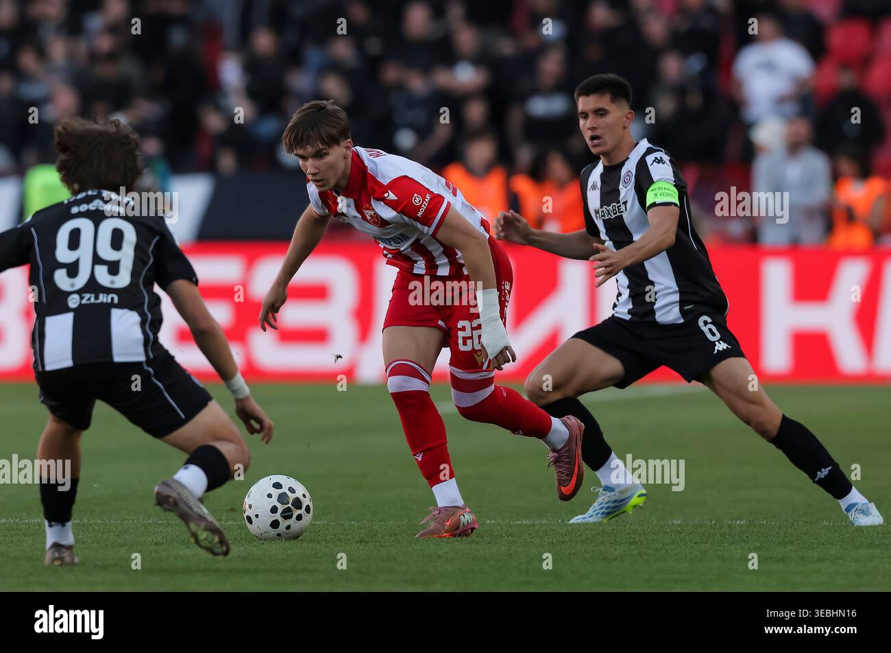 Belgrade, Serbia. 26 April, 2026. Vasilije Kostov (C) of Crvena Zvezda in action against Bogdan Kostic (L) and Vanja Dragojevic of Partizan during Serbian Super