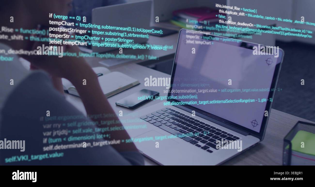 Coding developer resting chin on hand, reviewing code at desk with open laptop and smartphone Stock Photo