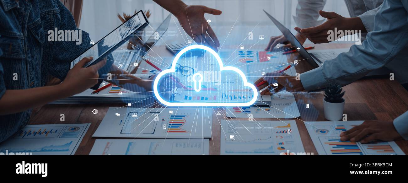 A team collaborates in a modern office setting, focusing on data security strategies with cloud computing visuals. Innovative discussions on Stock Photo