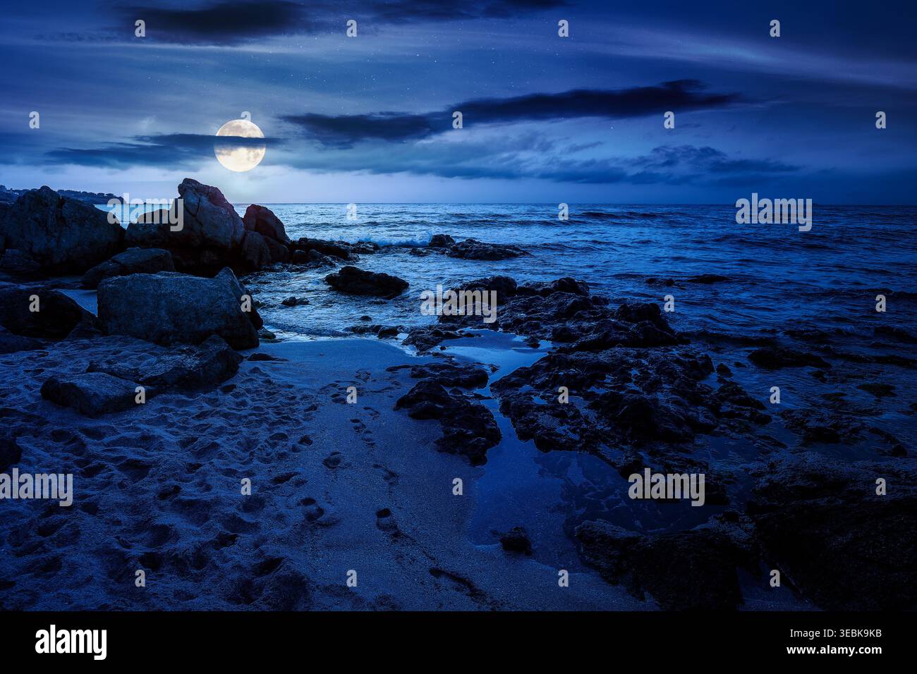 sandy beach landscape at night. full moon over coastal seascape scenery. mysterious nature background for summer vacation at the shore of black sea wi Stock Photo