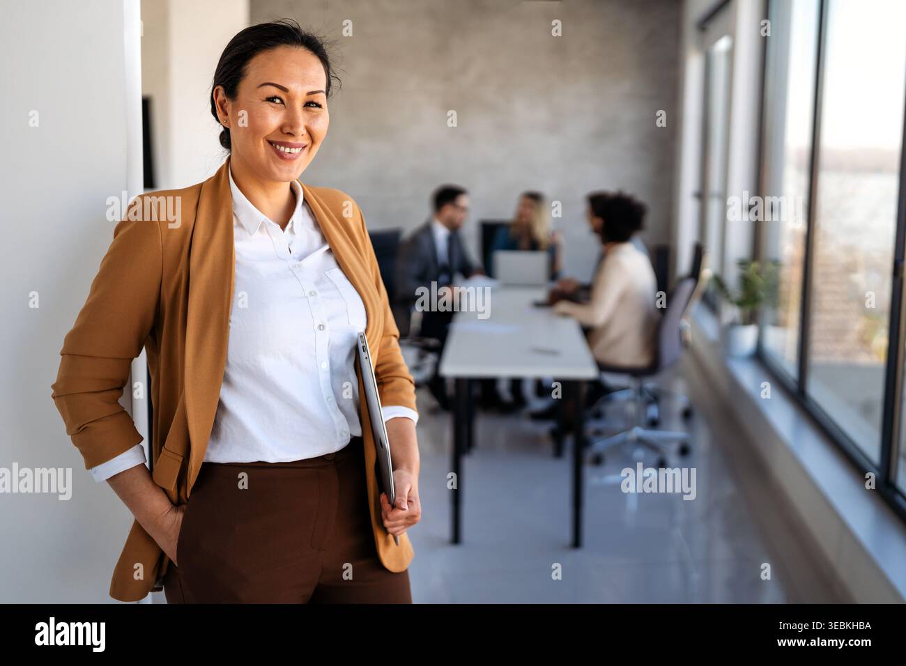 Professional in office environment, highlighting teamwork, collaboration, leadership, and innovation Stock Photo