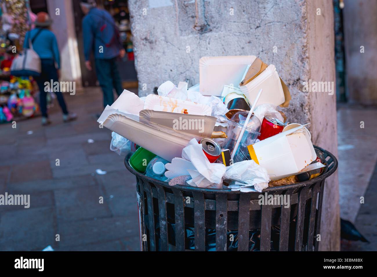 garbage piles inside dumpster in venice city, consequence of over tourism, litter bags overflow trash cans Stock Photo