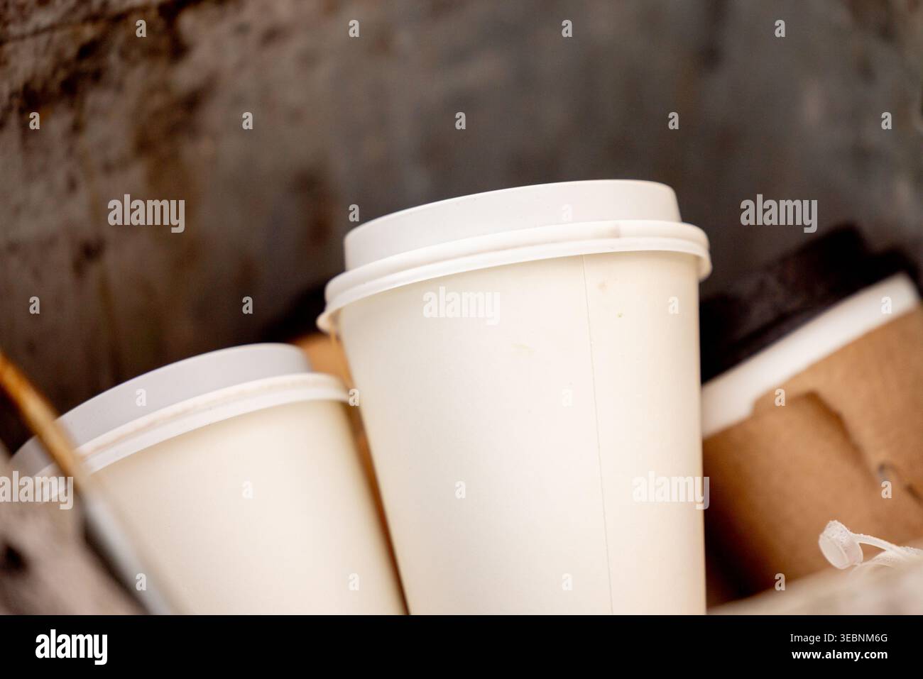 Disposable coffee cups in trash bin urban waste and recycling Stock ...