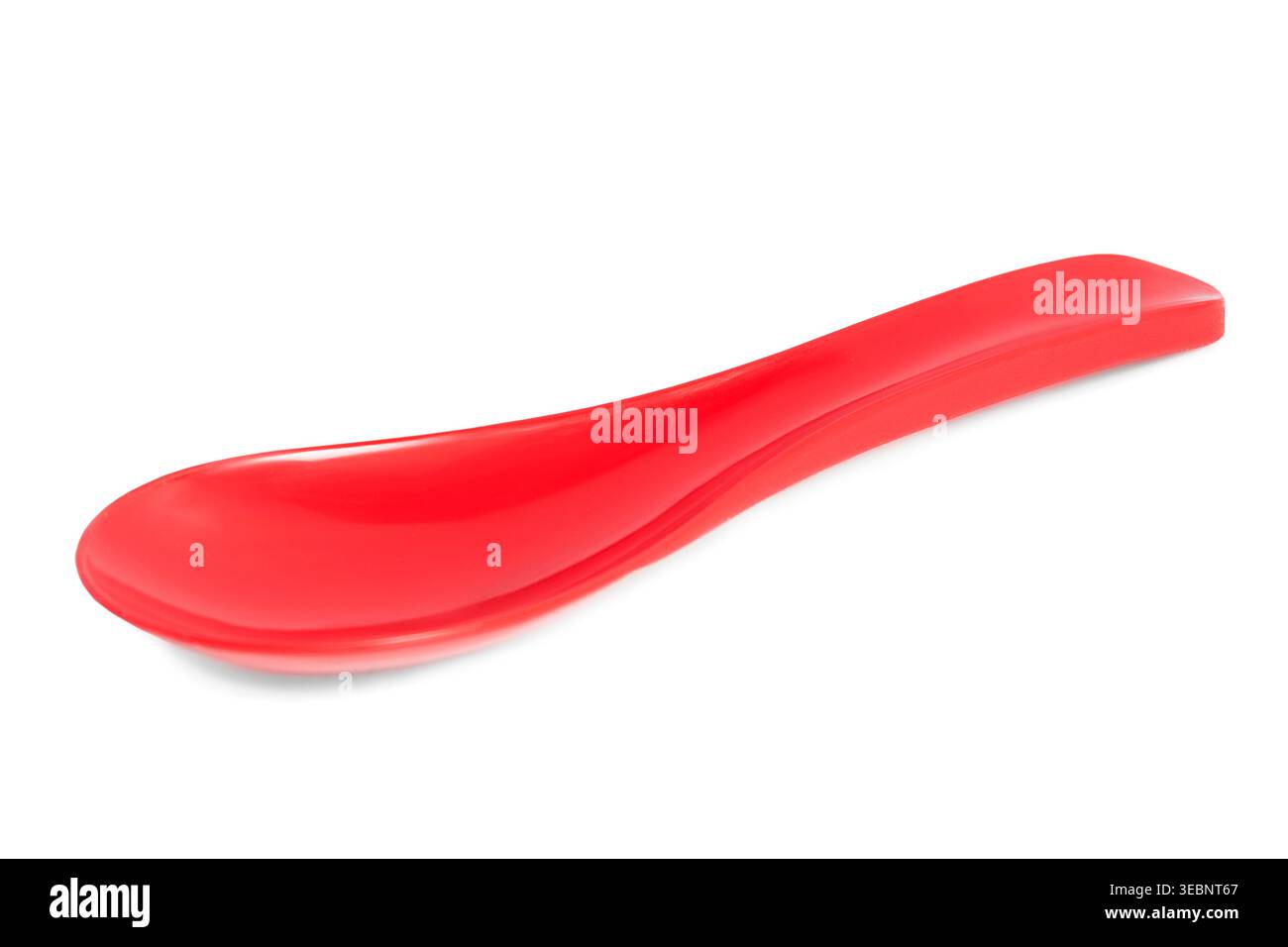 Red plastic spoon lying on white background Stock Photo